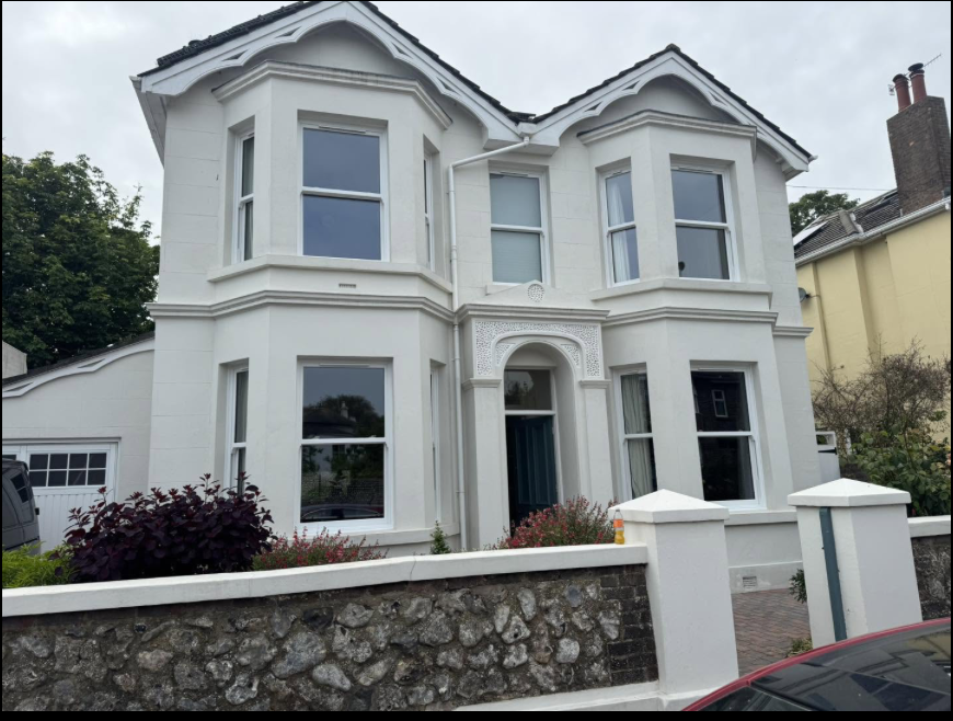 White rendered Victorian house in Worthing with new white bay windows